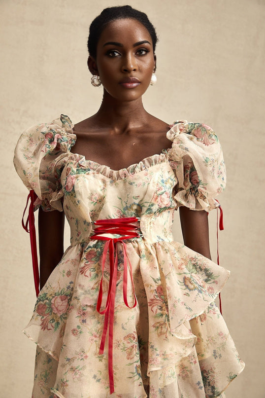 A floral print mini dress with layered tulle skirt and tie up detail named Salome