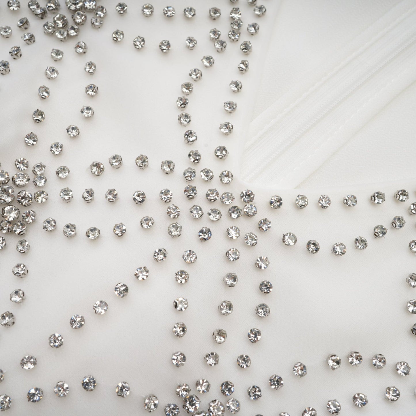 A flowing embellished dress with intricate detailing named Magdalena