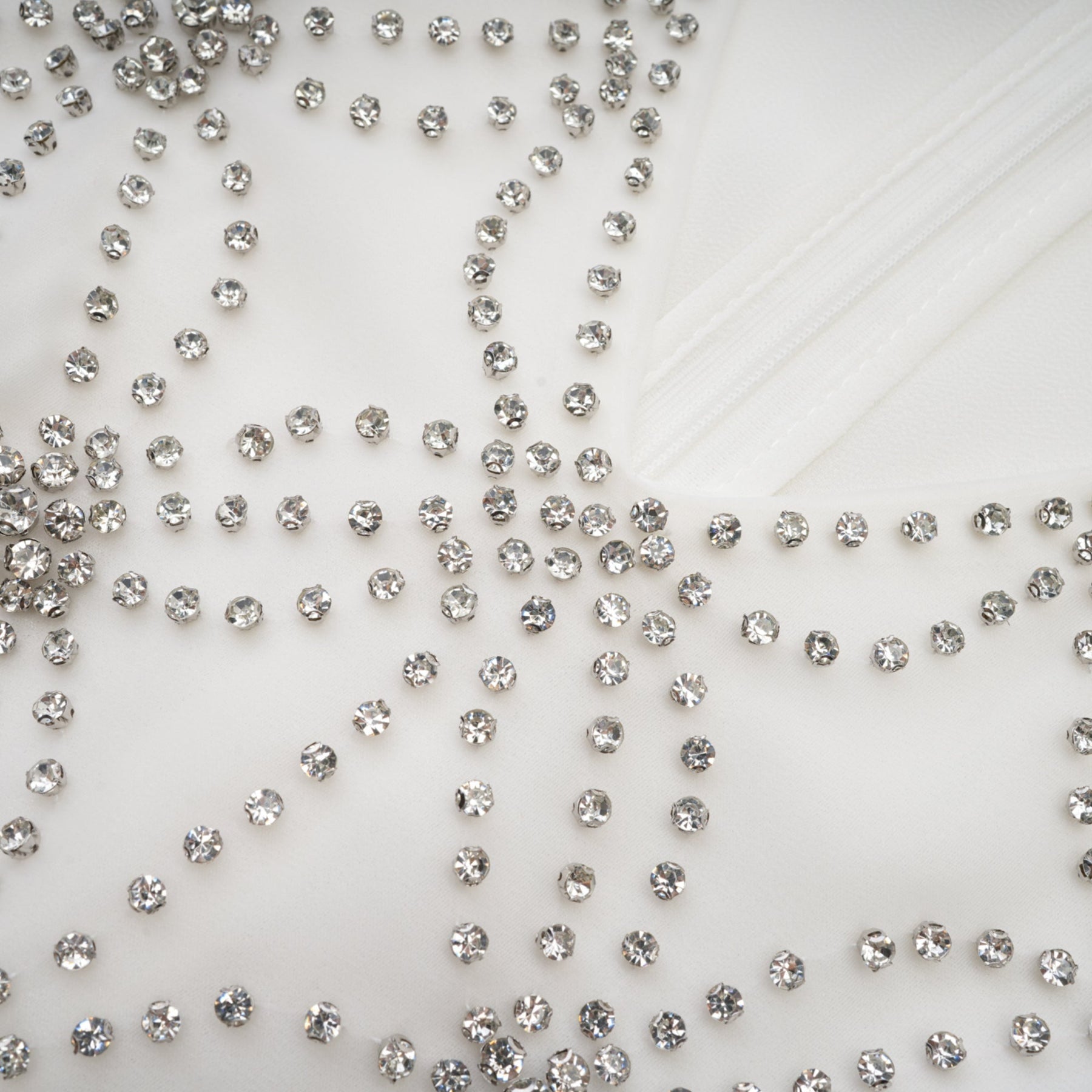 A flowing embellished dress with intricate detailing named Magdalena