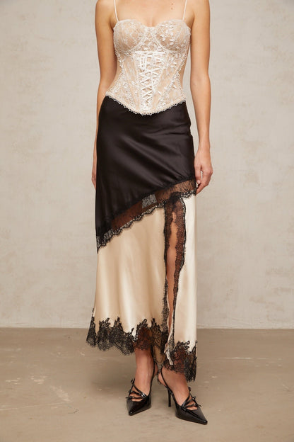 A flowing satin skirt with an asymmetric hem featuring delicate lace panels Raphaelle design in elegant fabric with contrasting textures