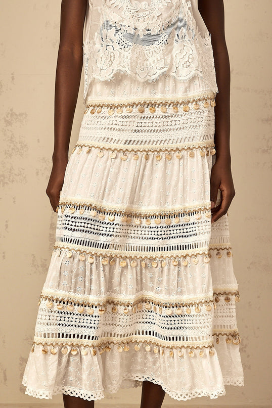 A flowy white midi skirt with shirred waistband in bohemian style