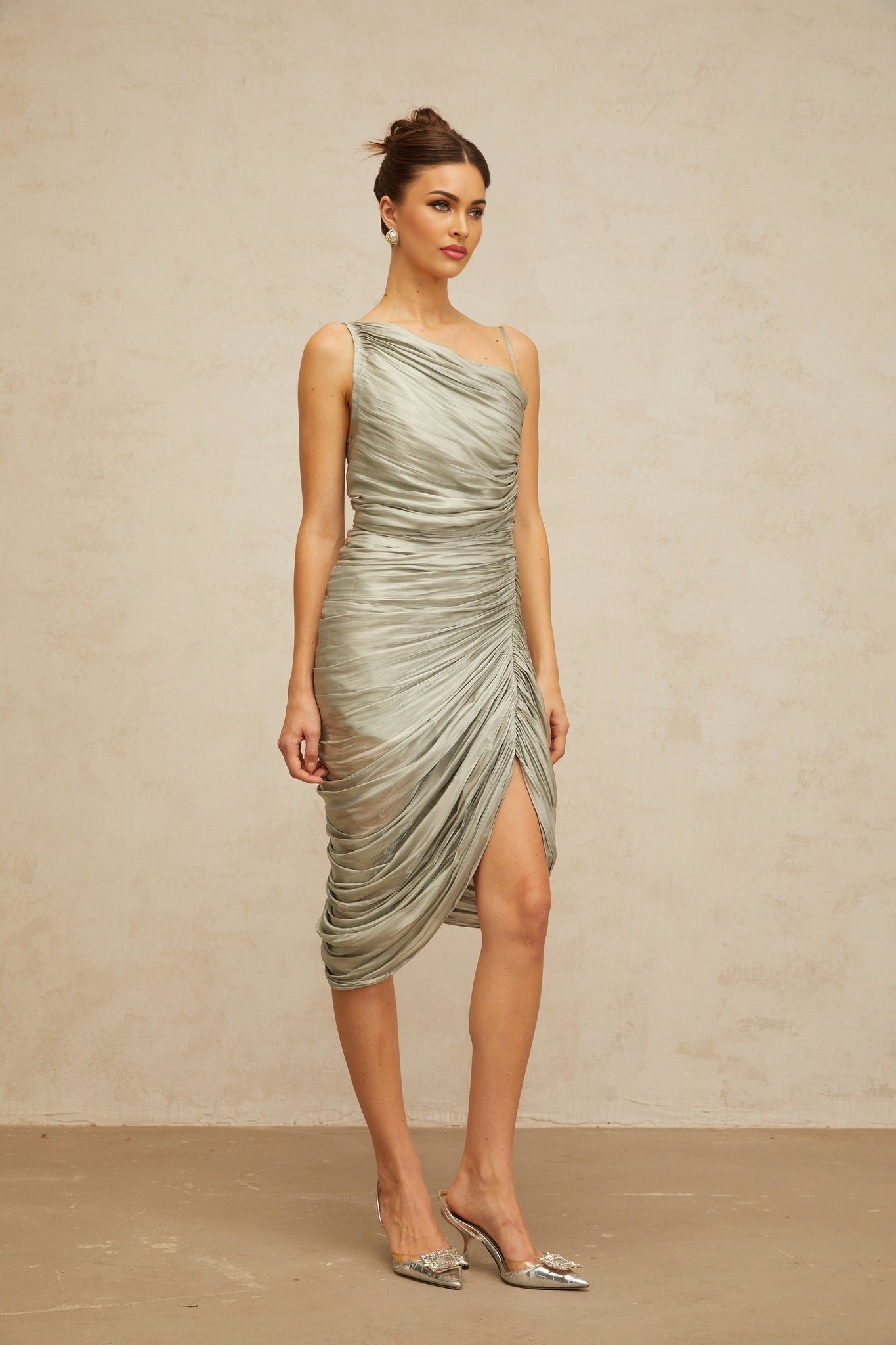 A grayishgreen glossy midi dress with ruched detailing featuring a sleek silhouette and formfitting design