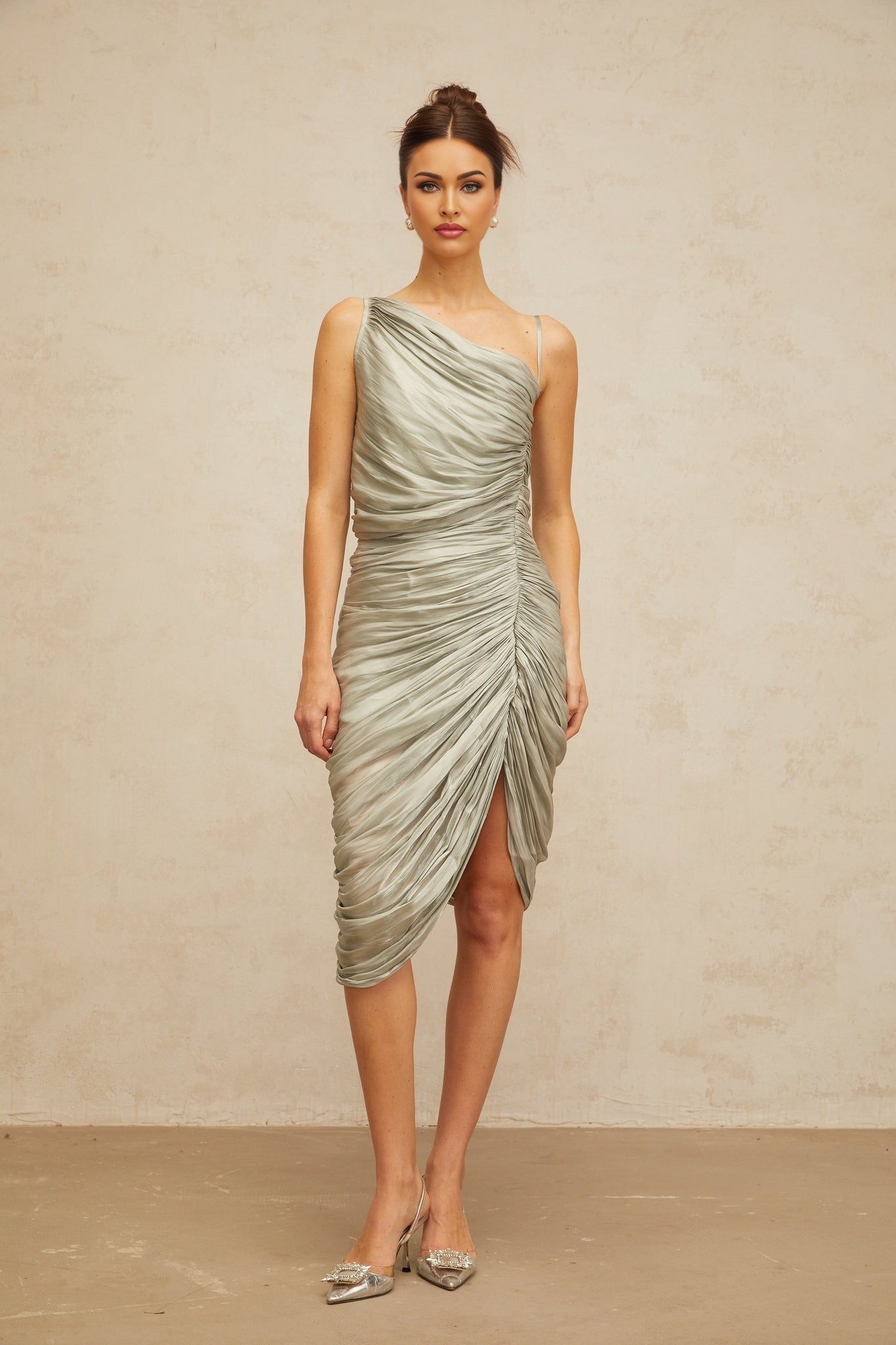 A grayishgreen glossy midi dress with ruched detailing featuring a slim fit and sleek silhouette
