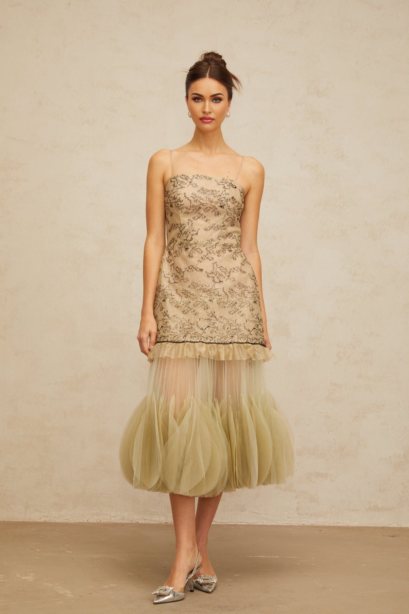 A green midi dress with embroidered details and panelled design named Mathilde