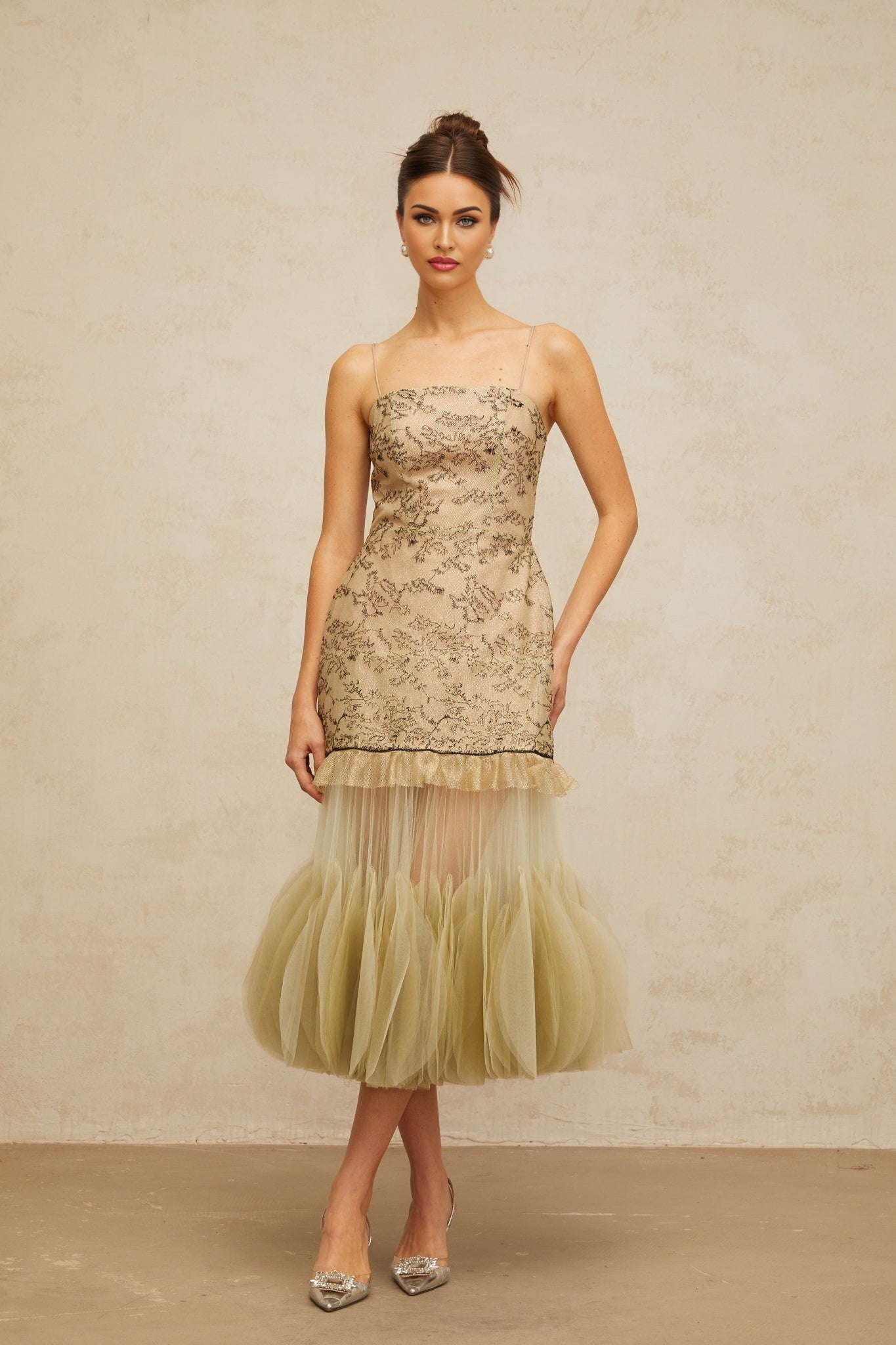 A green midi dress with embroidered details and panelled design named Mathilde