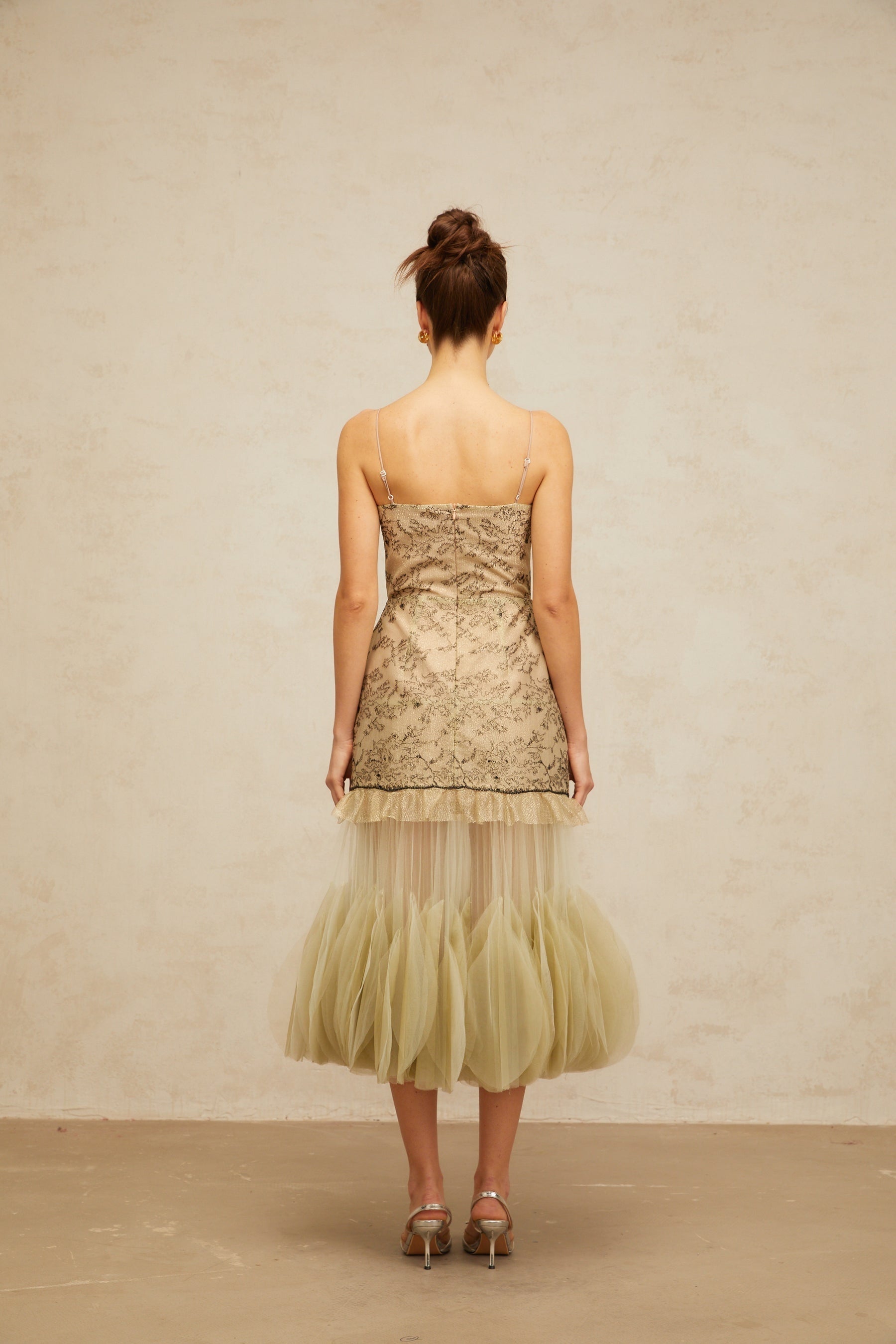 A green midi dress with embroidered details and panelled design named Mathilde