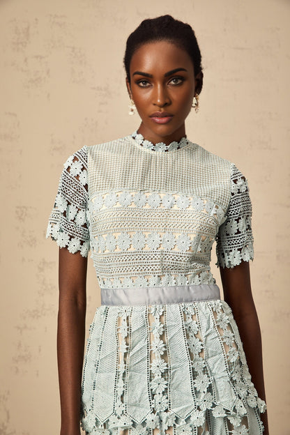 A green midi dress with floral embroidery details featuring a design inspired by ocean themes