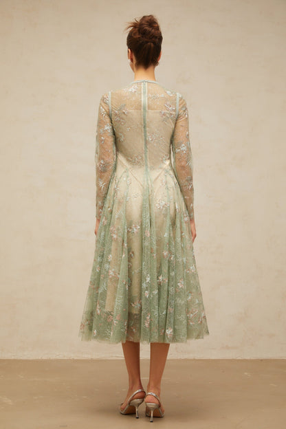 A green pleated midi dress with floral embroidery details featuring a design called Philomene