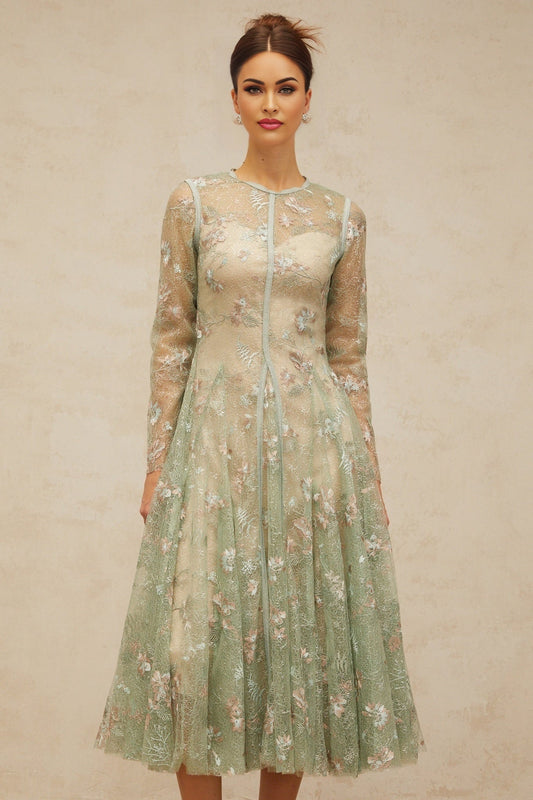 A green pleated midi dress with floral embroidery details featuring a design called Philomene