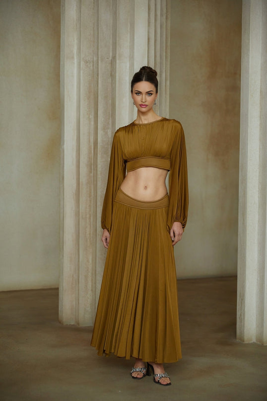 A green two piece outfit consisting of a fully pleated blouse and matching skirt named Daphne