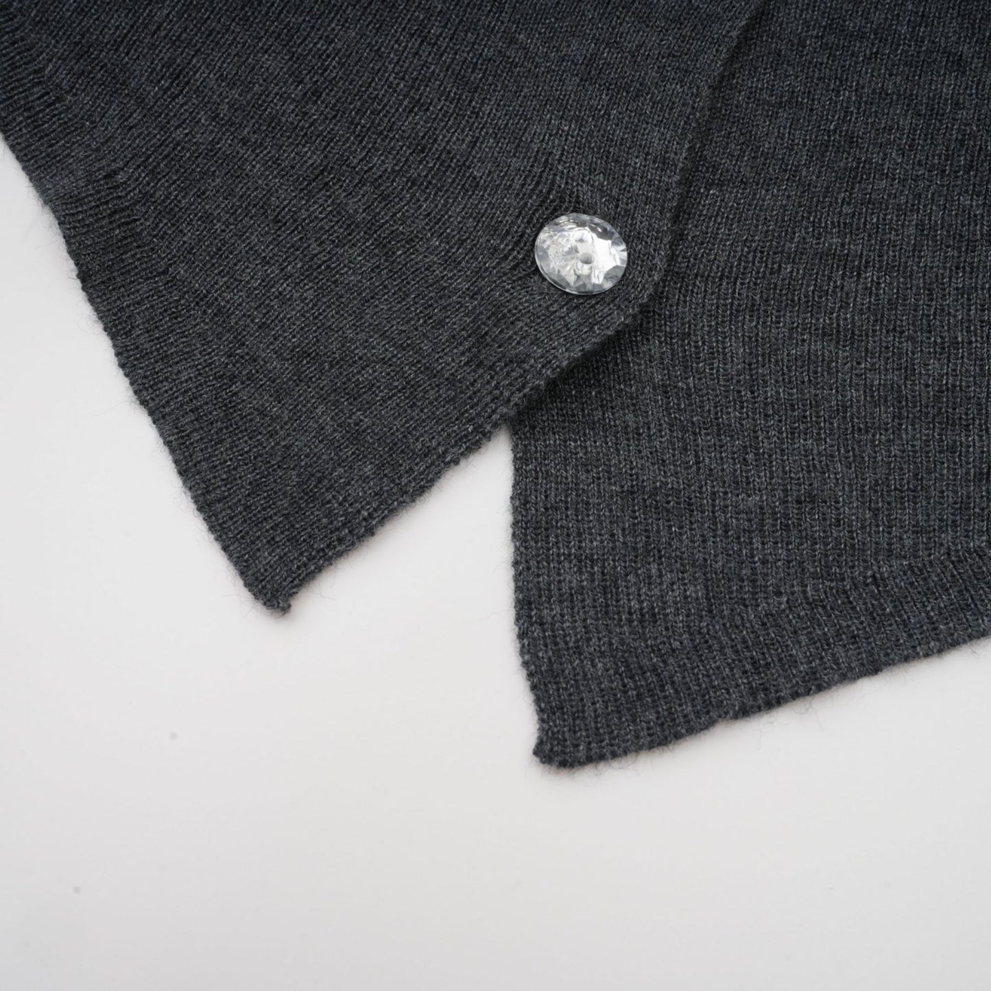 A grey cardigan with a butterfly design made of sequins featuring the Anastasie brand