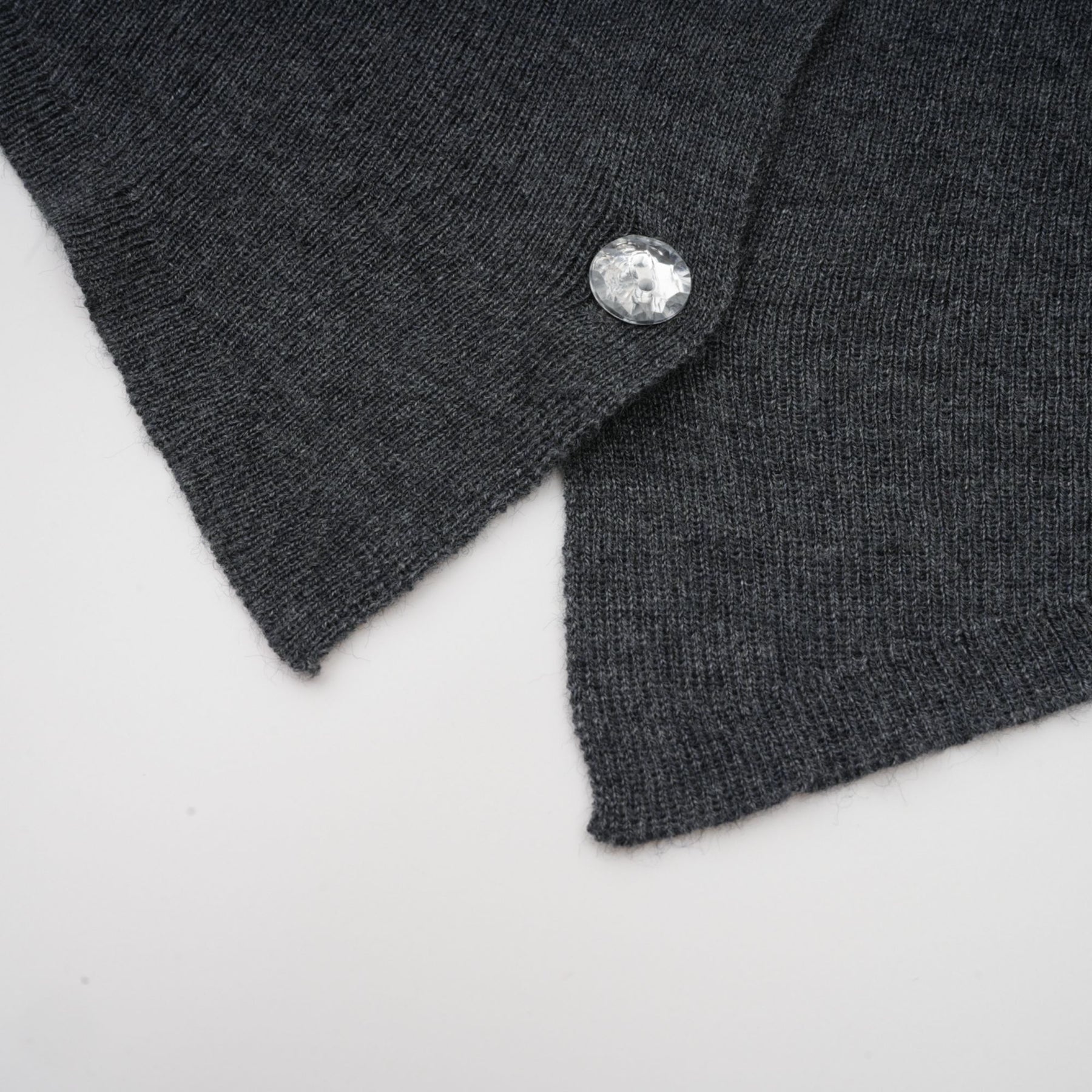 A grey cardigan with a butterfly design made of sequins featuring the Anastasie brand