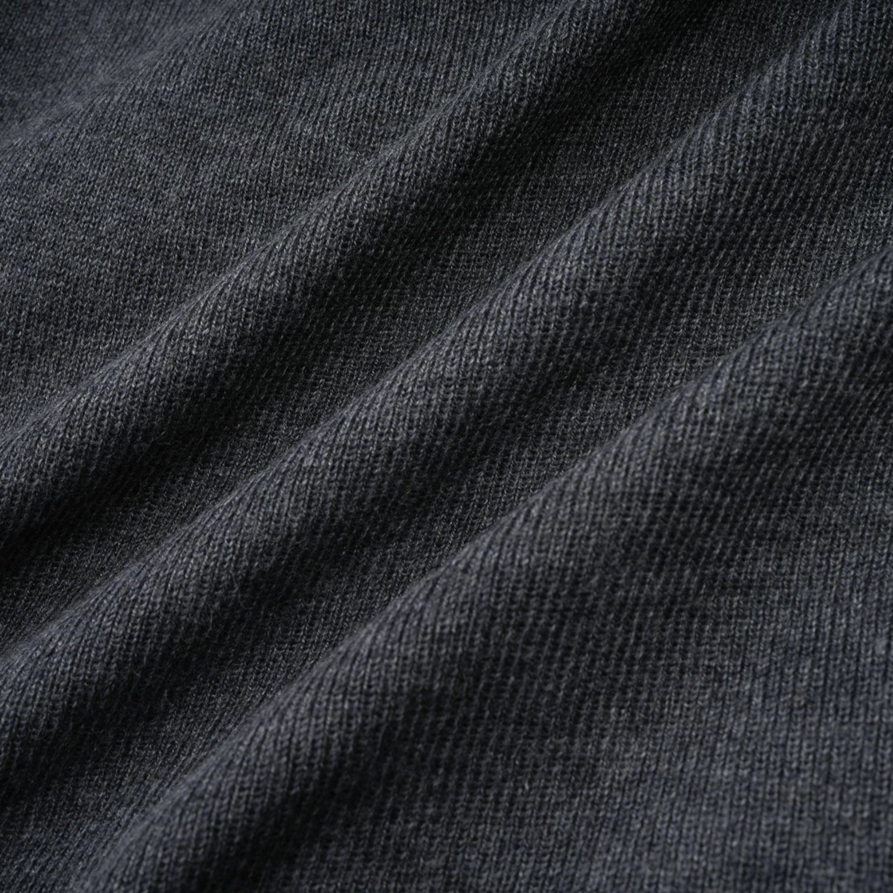 A grey cardigan with sequined butterfly designs adorning the fabric
