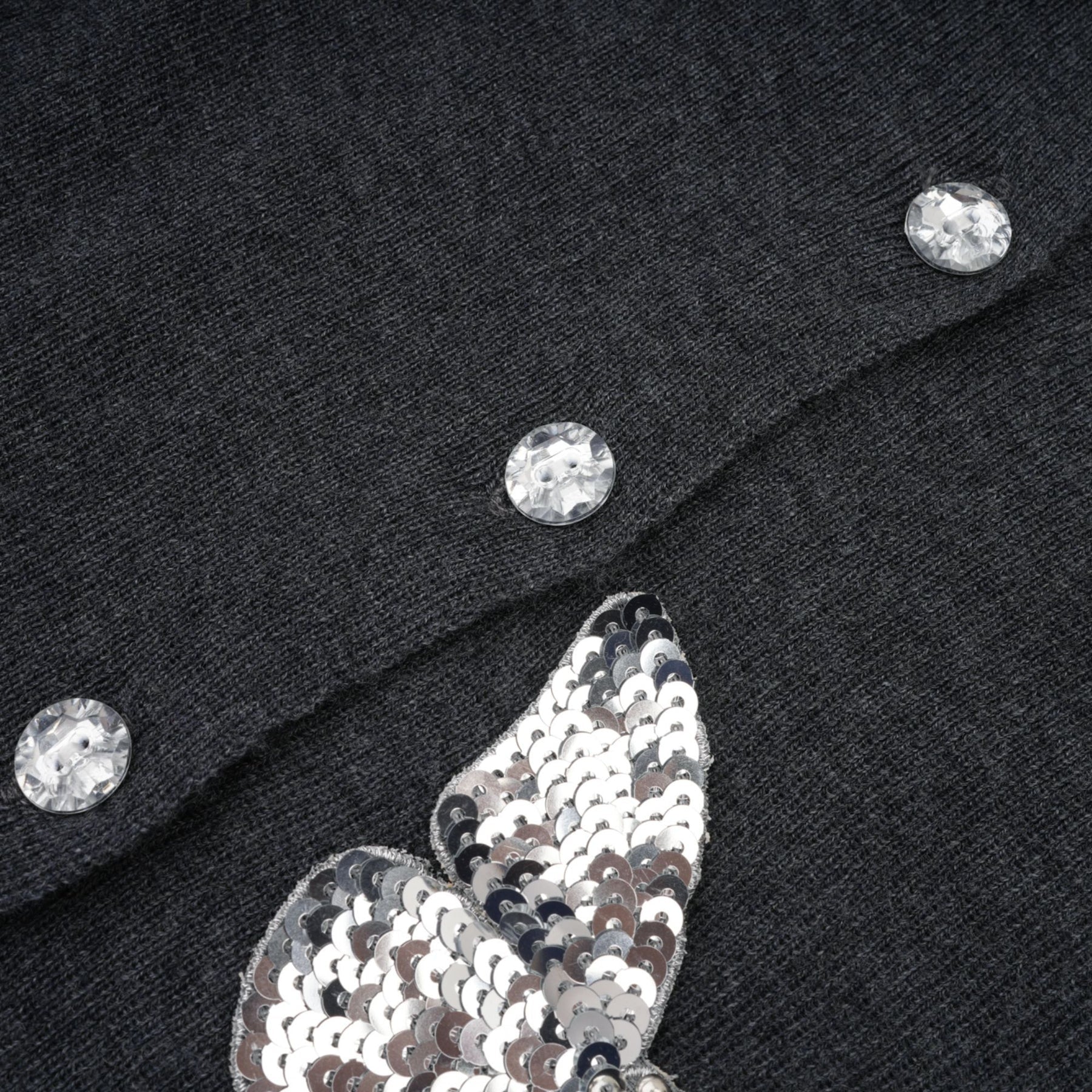 A grey cardigan with sequined butterfly designs on it