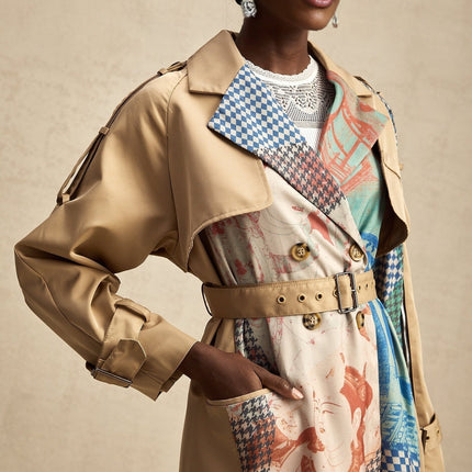 A Joséphine trench coat with contrasting colors and a printed design featuring a belt at the waist