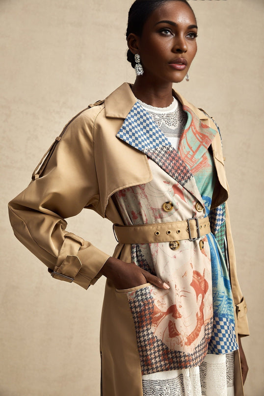 A Joséphine trench coat with contrasting colors and a printed design featuring a belt at the waist