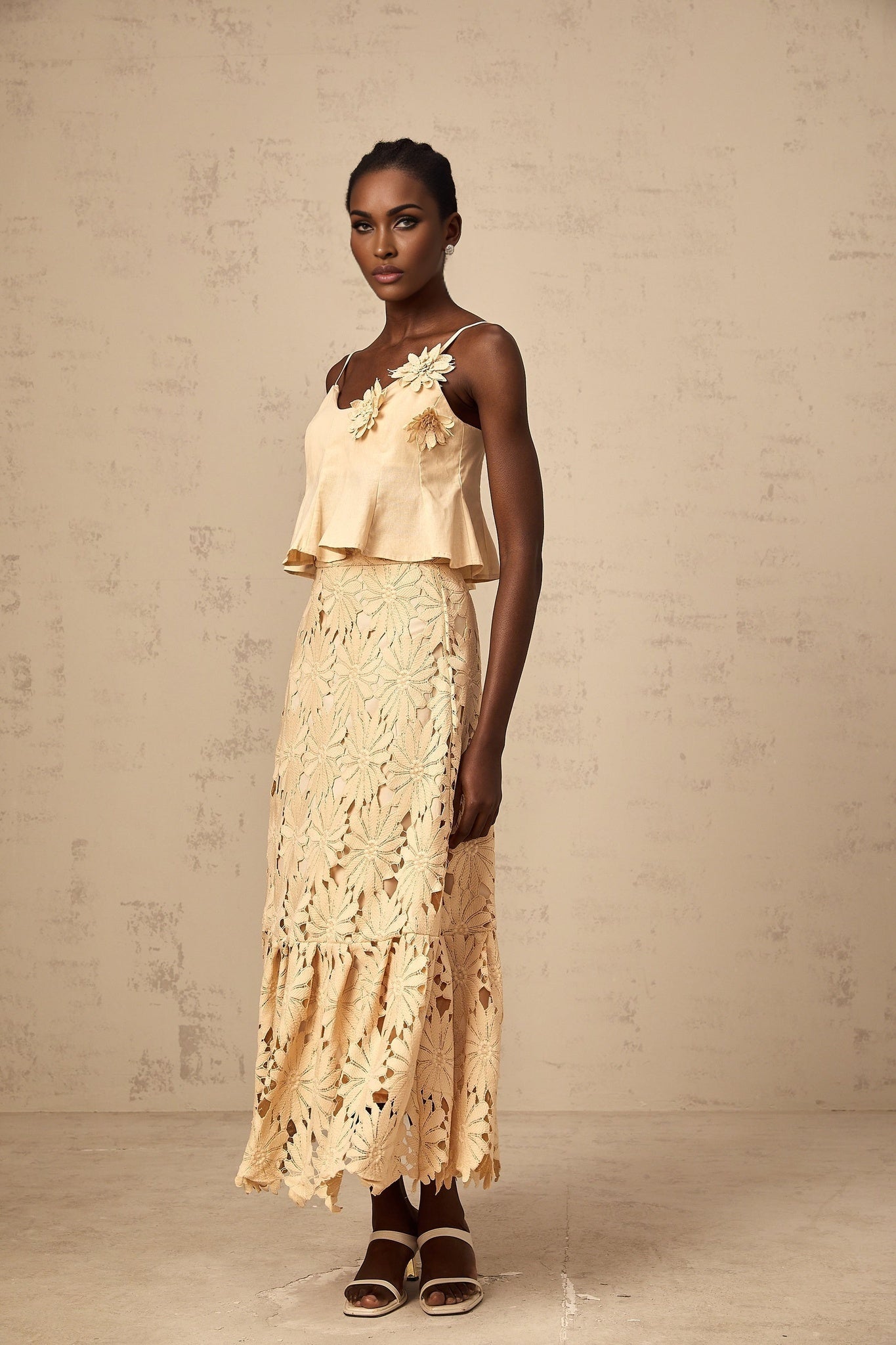 A khaki colored matching set featuring a cutout flared top and skirt by Celine