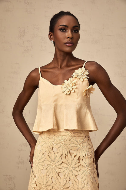 A khaki colored matching set from Celine featuring a top with cutout details and a flared skirt