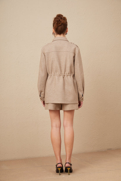 A khaki colored wool twill jacket and matching culottes set from Clarisse shown together as a coordinated outfit
