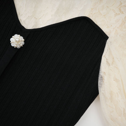 A knit midi dress with lace trim detailing named Noa