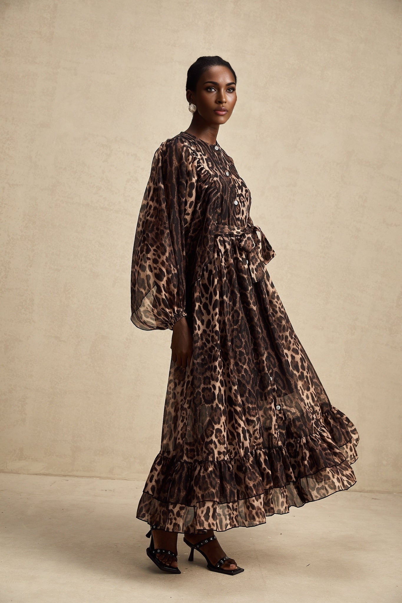 A leopard print midi dress with a single breasted design featuring the Gisele style