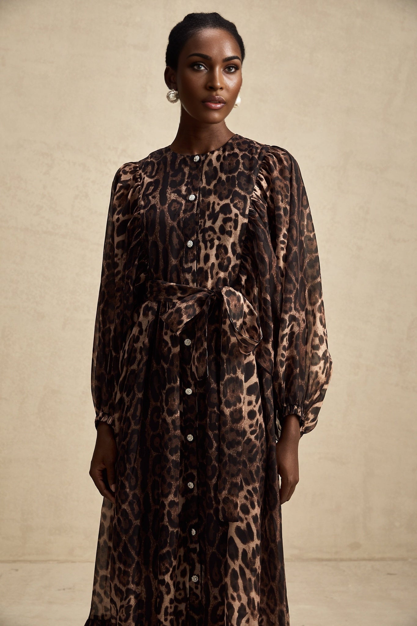 A leopard print midi dress with a single breasted design featuring the Gisele style