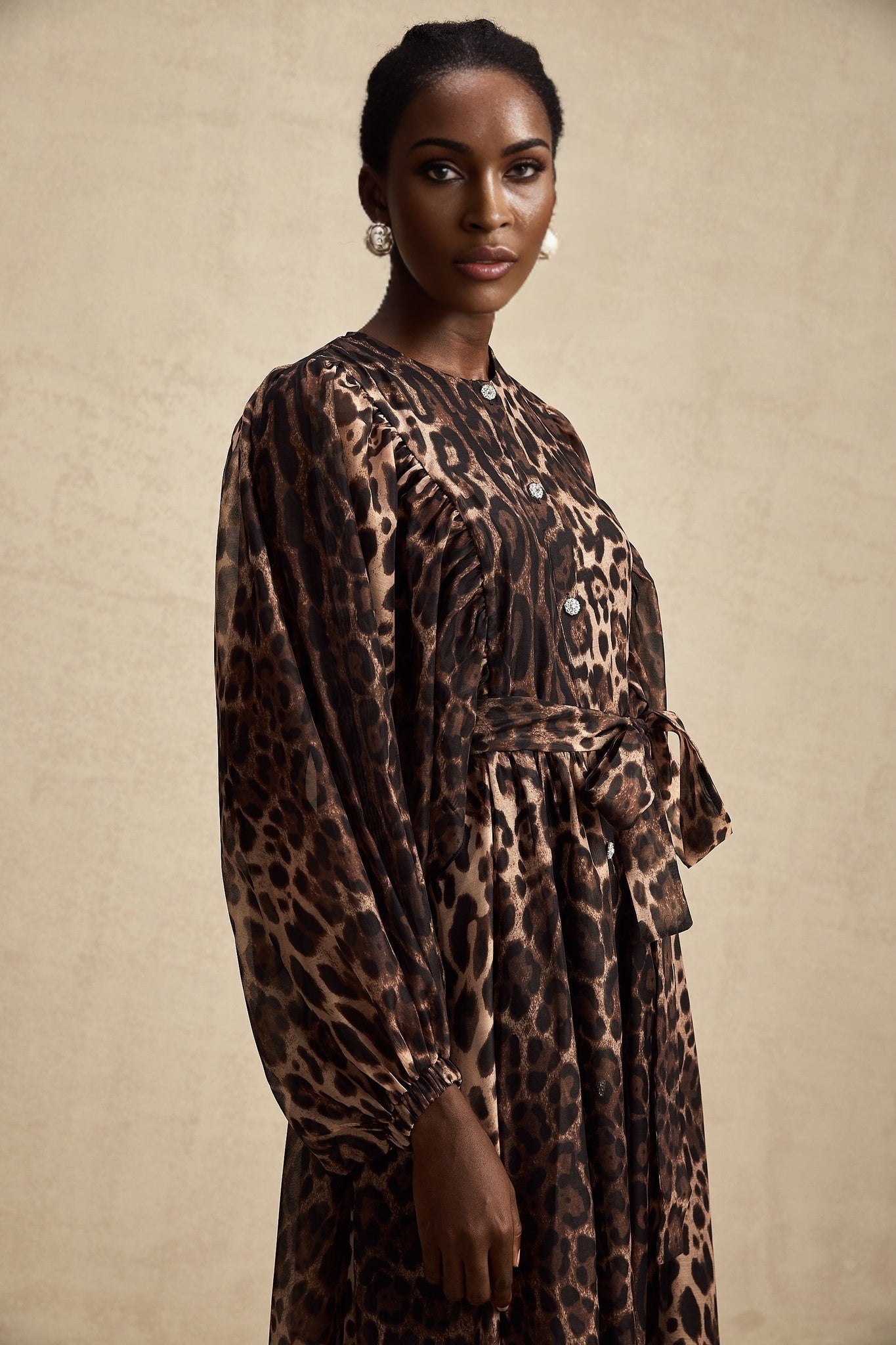 A leopard print midi dress with a single breasted design featuring the Gisele style