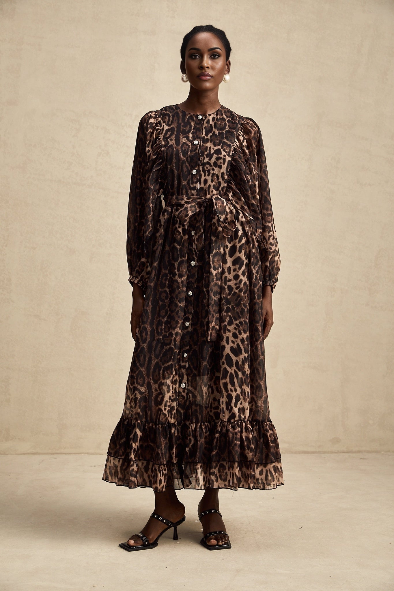 A leopard print midi dress with a single breasted design featuring the Gisele style