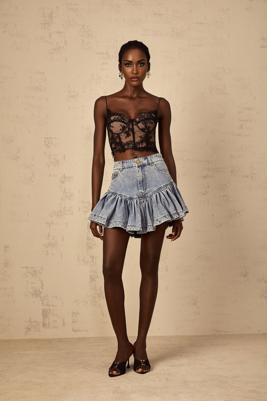 A light blue denim mini skirt with ruffled details called the Florence skirt