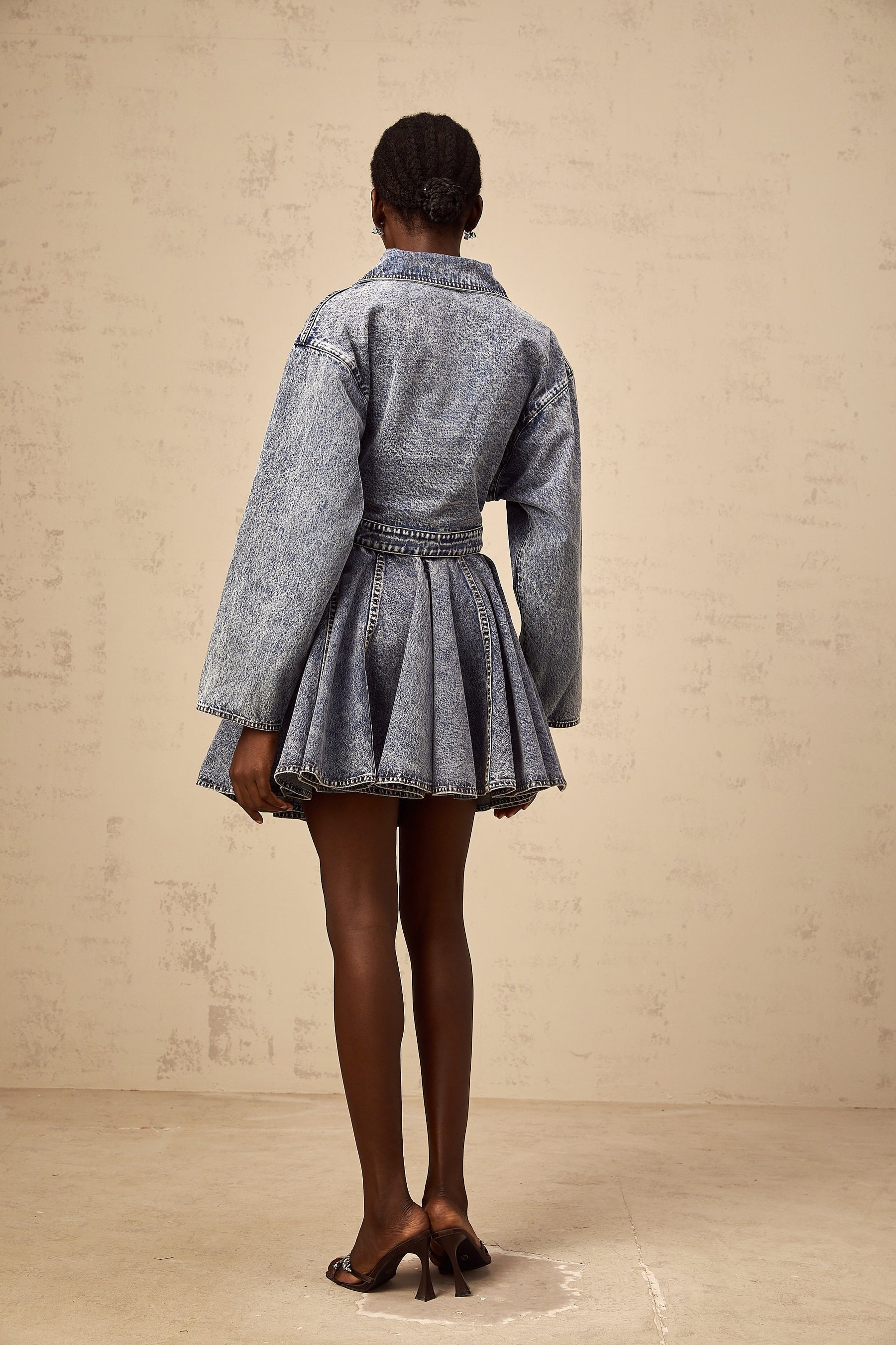 A light blue denim mini skirt with shirred waistband and slightly flared design
