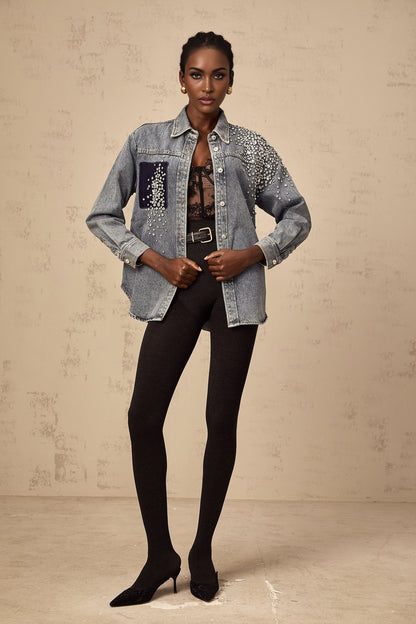 A light blue denim shirt adorned with small rhinestones scattered across the fabric creating a sparkling effect