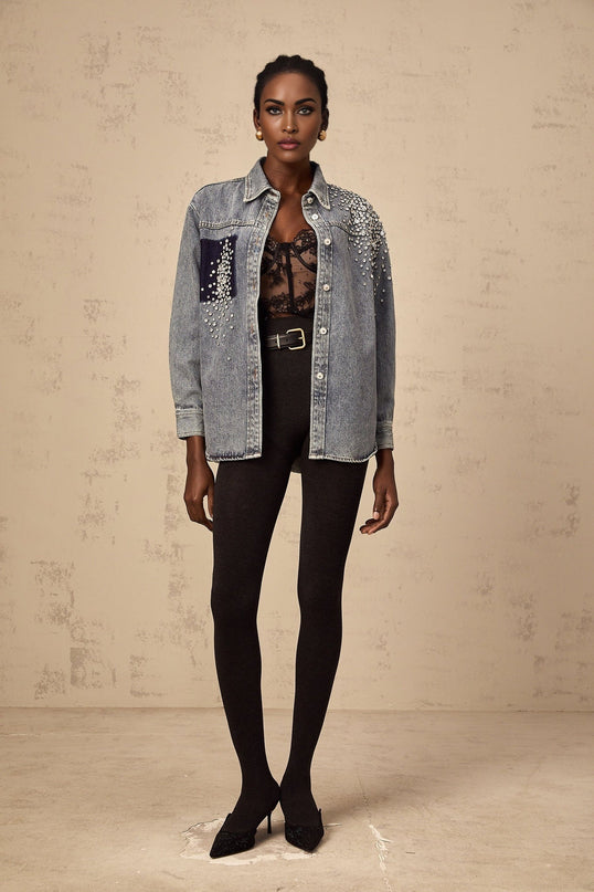 A light blue denim shirt with sparkling rhinestone embellishments scattered across the fabric