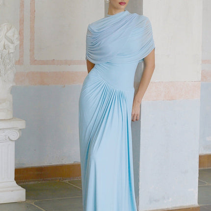 A light blue floorlength dress with an asymmetric neckline and pleated skirt details worn by a model against a plain background