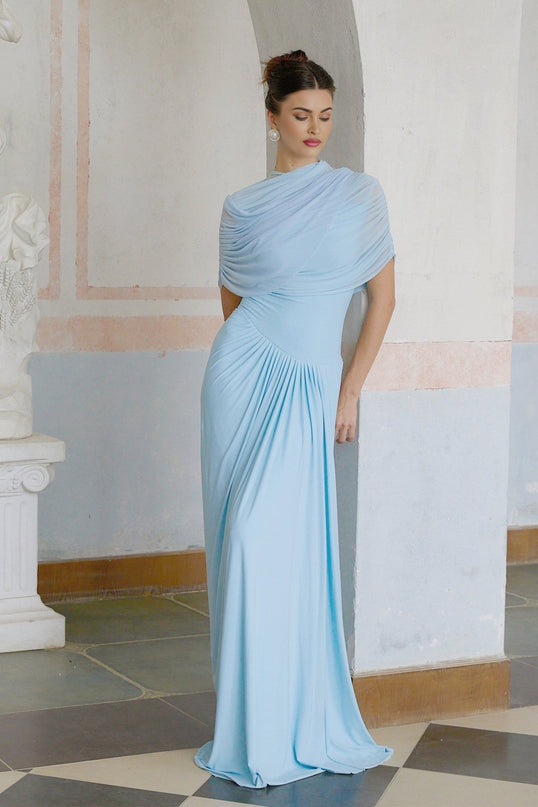 A light blue floorlength dress with an asymmetric neckline and pleated skirt details worn by a model against a plain background