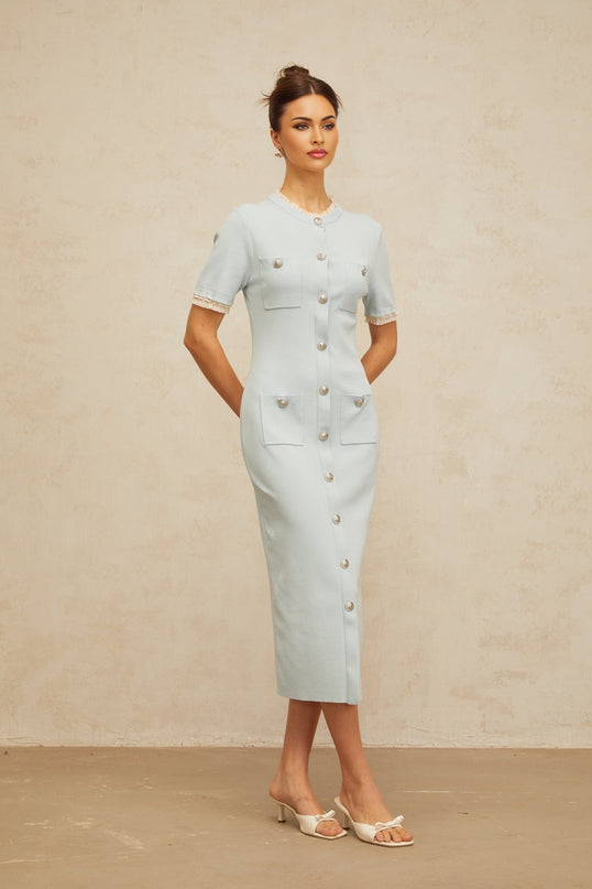 A light blue knit midi dress with a fitted pencil silhouette featuring a sleek and elegant design
