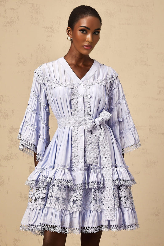 A light blue mini dress with tiered layers and delicate floral embroidery featuring a short hemline and feminine design by Gaelle