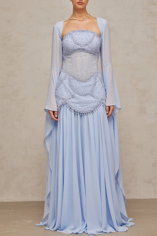 A light blue pleated maxi dress with faux pearl embellishments by Gaelle