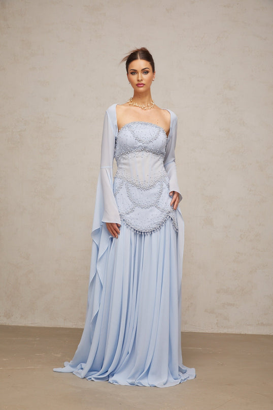 A light blue pleated maxi dress with faux pearl embellishments by Gaelle