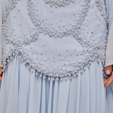 A light blue pleated maxi dress with faux pearl embellishments by Gaelle
