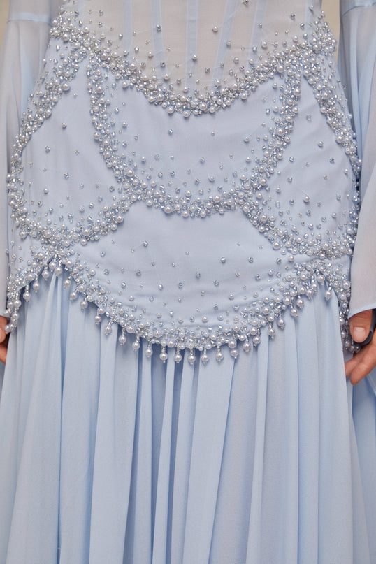 A light blue pleated maxi dress with faux pearl embellishments by Gaelle