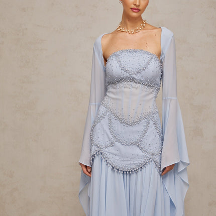 A light blue pleated maxi dress with faux pearl embellishments by Gaelle