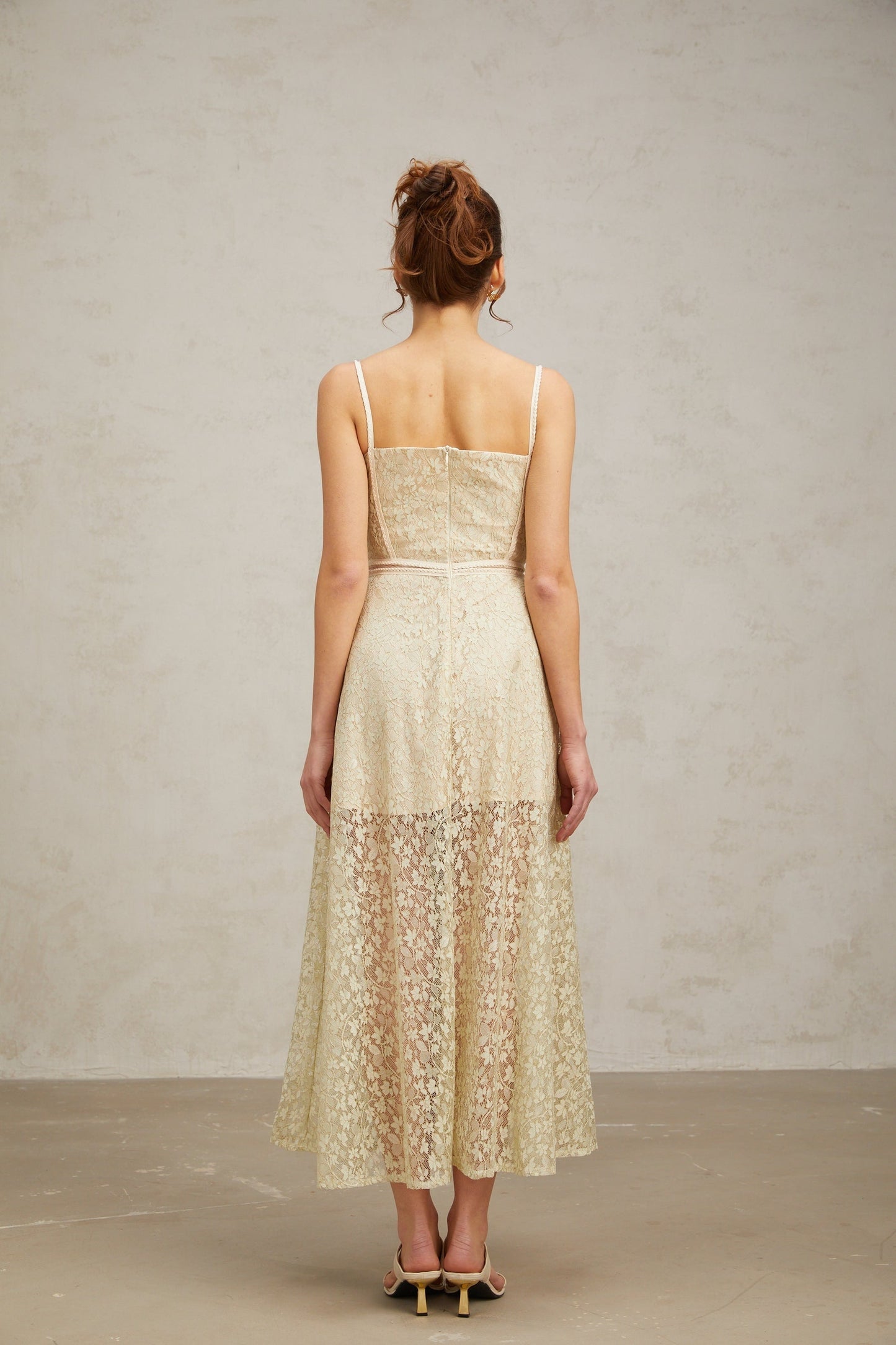 A light green midi dress with floral embroidery detailing named Yasmine