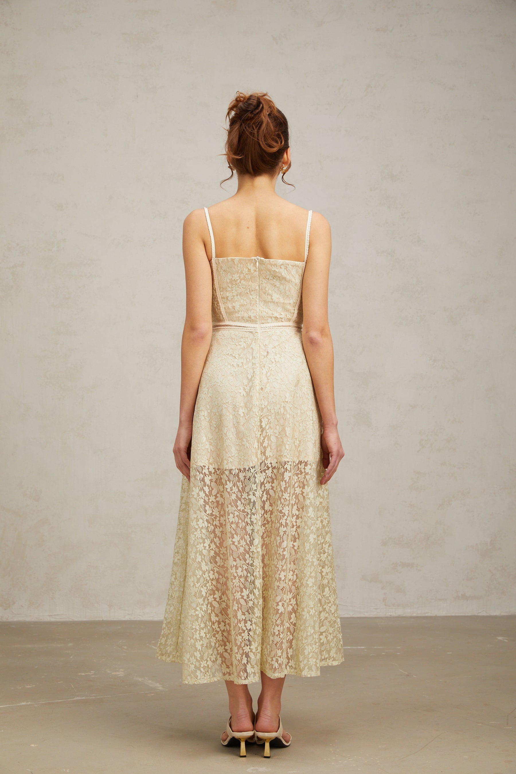 A light green midi dress with floral embroidery detailing named Yasmine