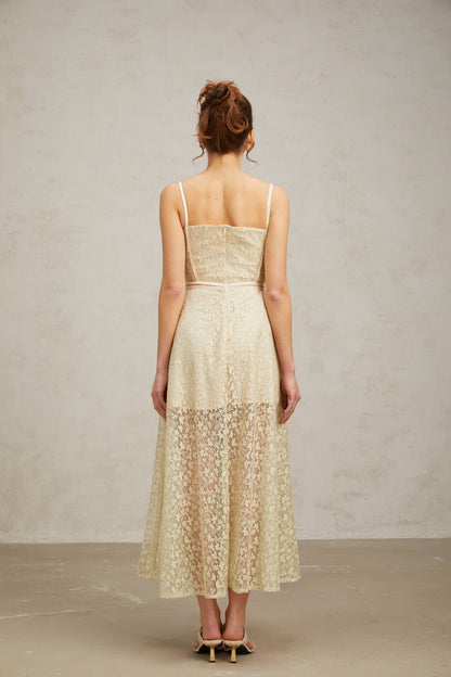 A light green midi dress with floral embroidery detailing named Yasmine