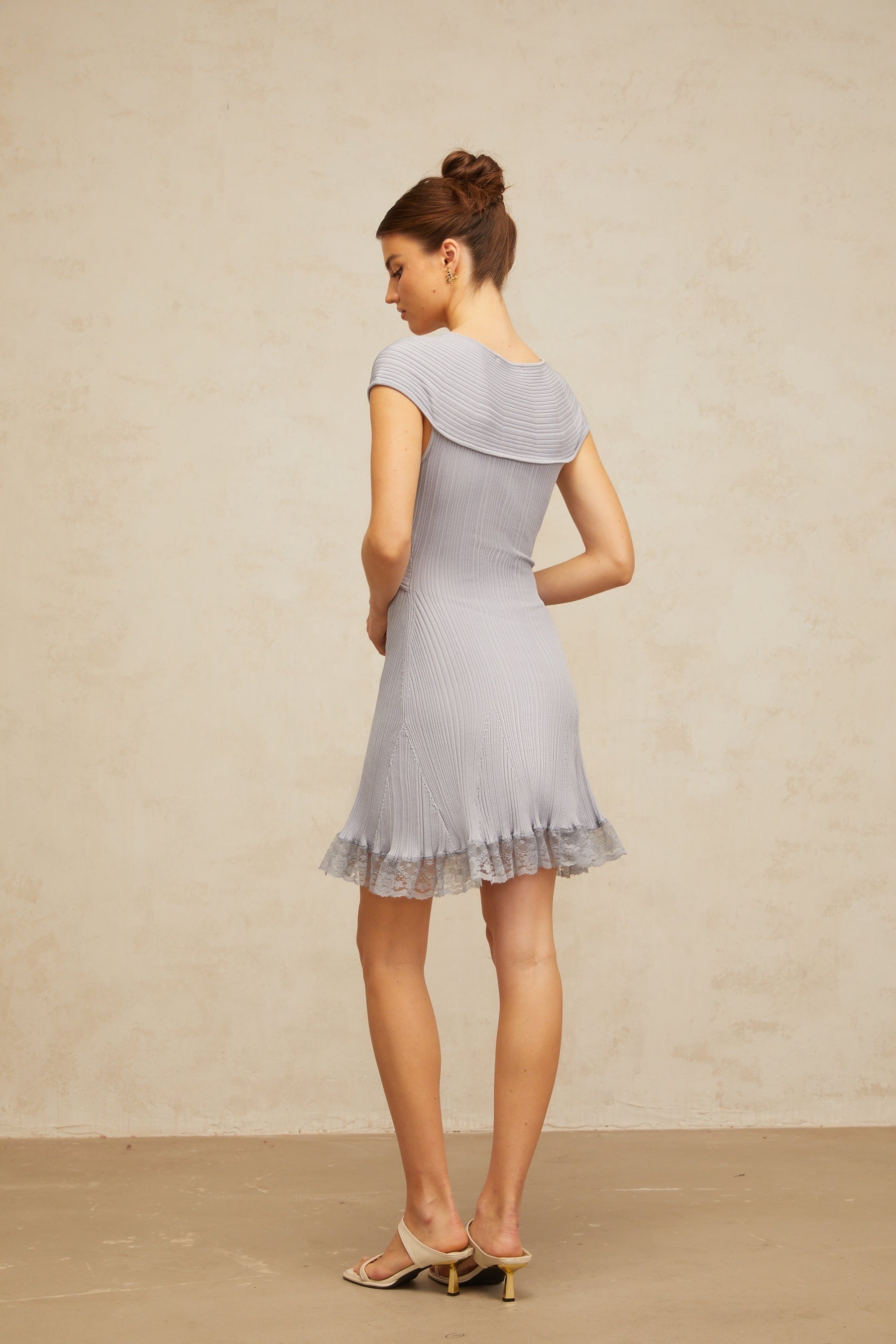 A light purple mini dress with a ribbed knit texture and crossover design at the front