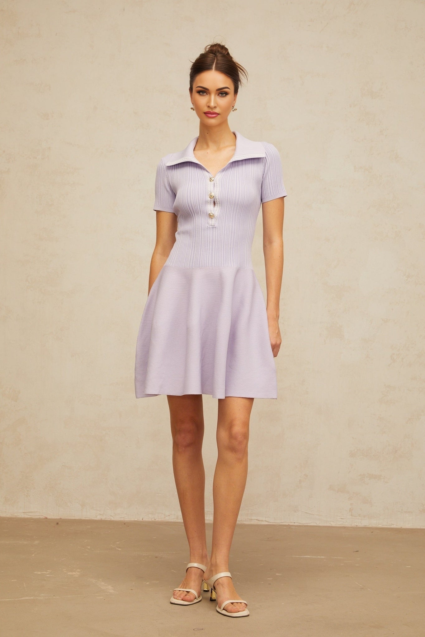 A lilac colored mini dress with a flared skirt and shirred bodice made of knit fabric named Vanessa