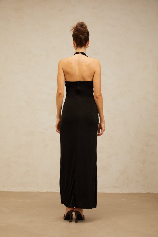 A long black denim maxi dress with a front slit and contrasting white stitching featuring Adrienne style