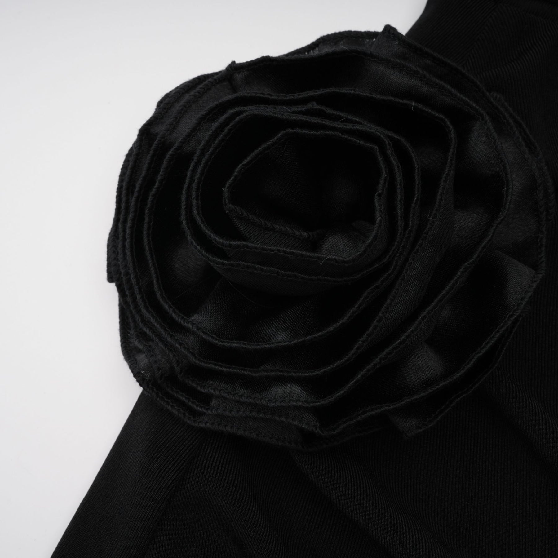A long black hooded maxi dress with floral applique detailing named Axelle