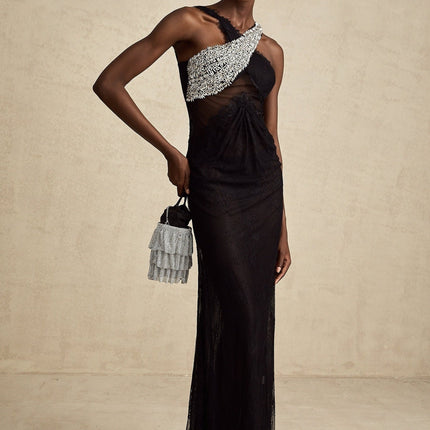 A long black maxi dress with a crossover bodice featuring crystal embellishments and a flowing skirt