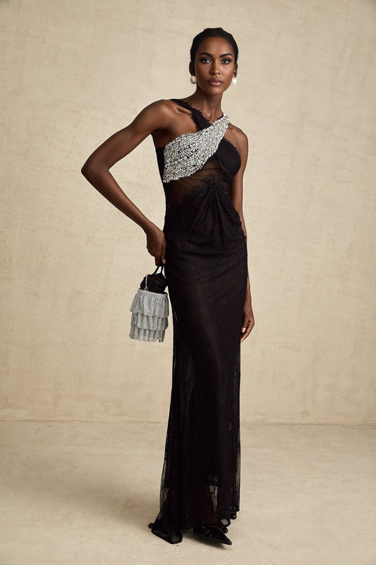 A long black maxi dress with a crossover bodice featuring crystal embellishments and a flowing skirt
